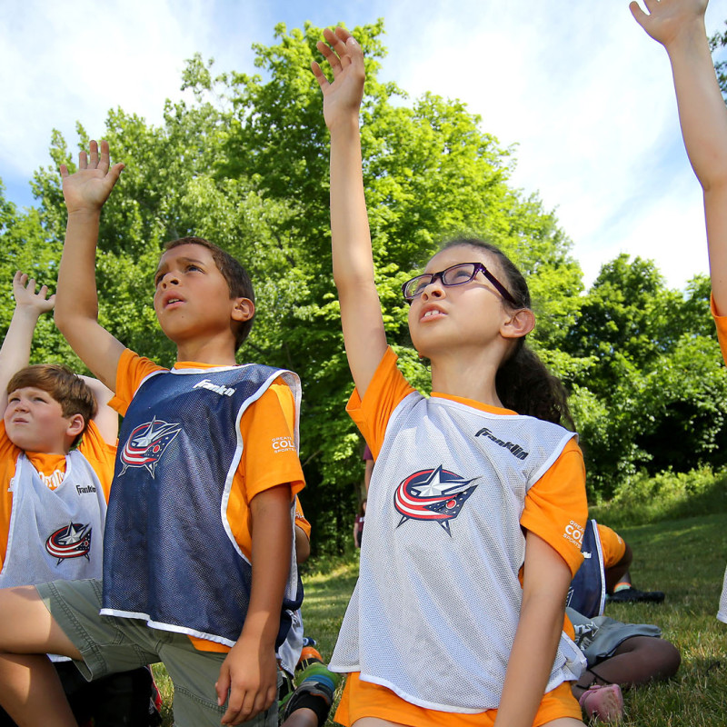 Children raising hands for questions