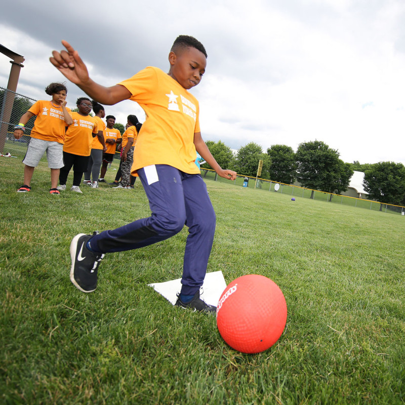 Child playing kickball