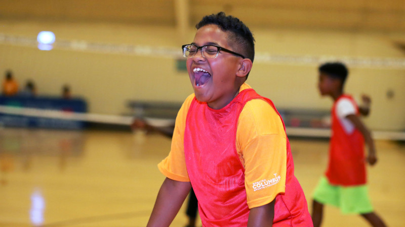 Young camper excited in the gym