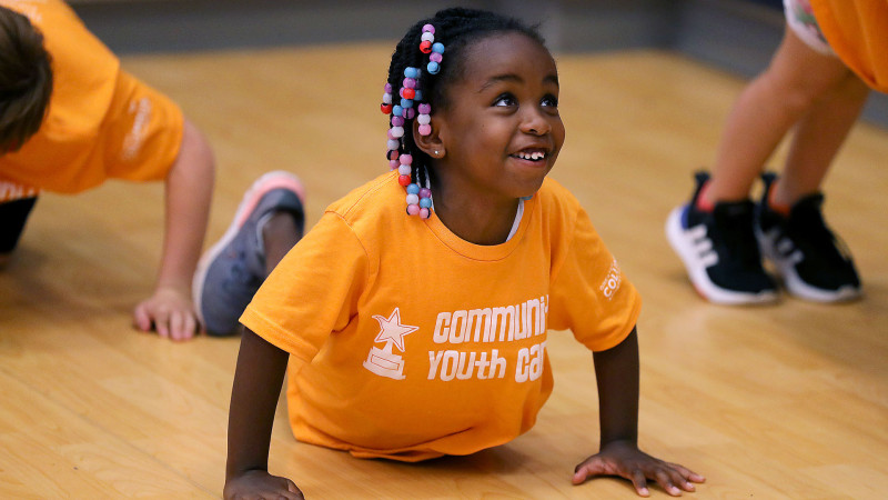 Young camper doing pushups