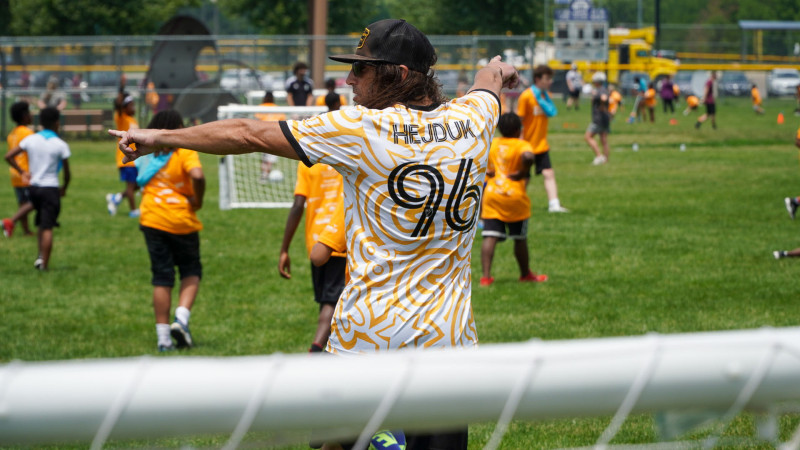 Coach instructing campers during soccer