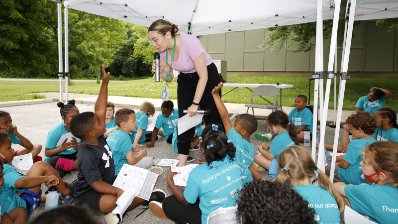 Volunteer answering children's questions