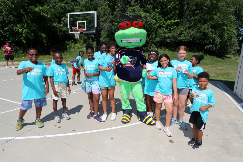 young camper playing field hockey