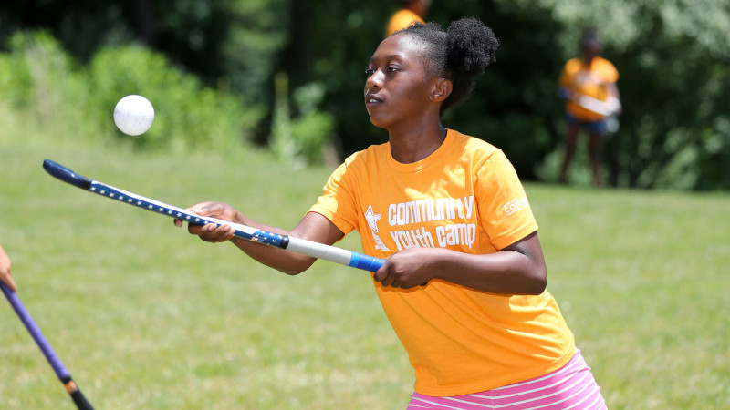 young camper playing field hockey